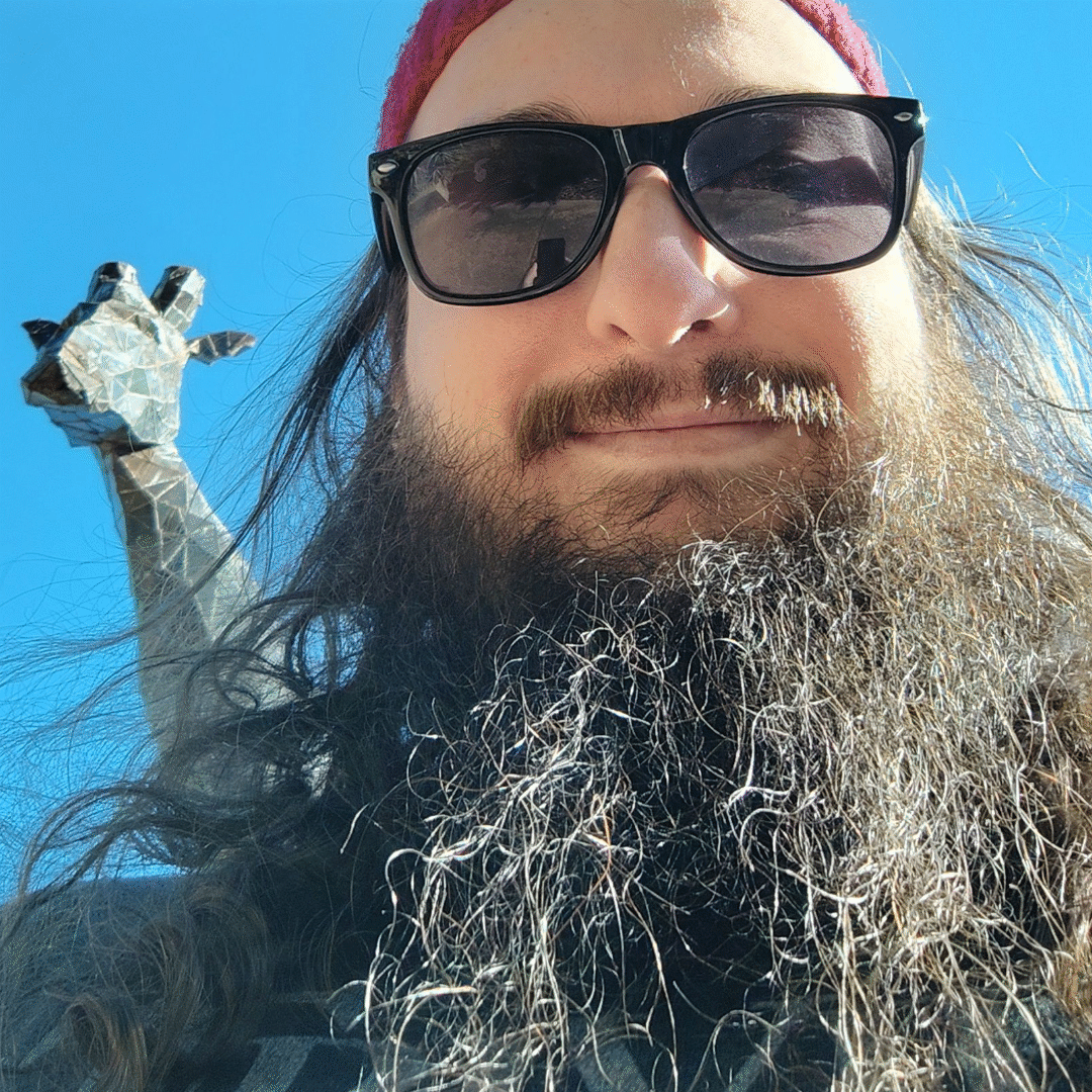 Fully bearded dev standing with a shit eating grin in front of a giraffe statue at the zoo.  Celebrating our anniversary with my girlfriend Amber.